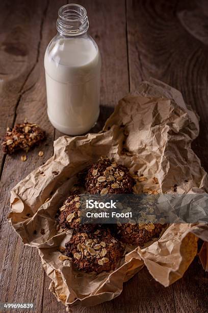 Homemade Oatmeal Cookies With Nuts And Bottle Of Milk Stock Photo - Download Image Now