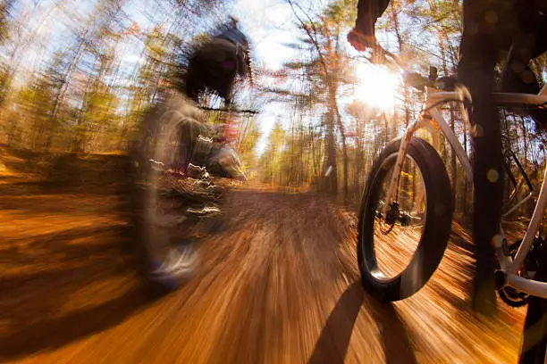 Two people riding fatbikes through the fall colors.