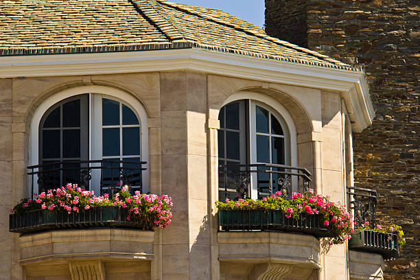 istock Beautiful balcony with white arched pane windows and flower boxes 499697539