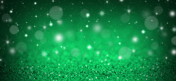 Christmas background with green glitters, sparkles and bokeh