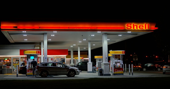 Santa Rosa, California, USA - May 31, 2014: People at a Shell gas station in Santa Rosa at night. Founded in 1907, Royal Dutch Shell, better known as just Shell, is a global energy company with 2011 revenues of over $470 billion.
