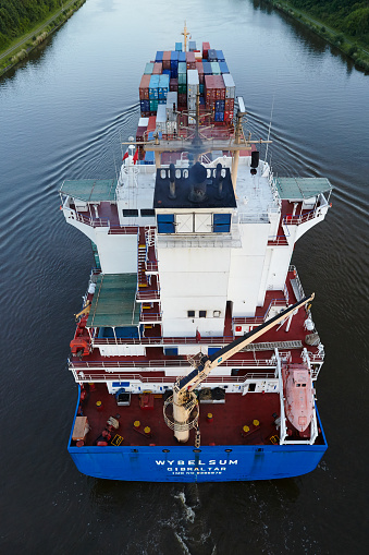 Beldorf, Germany - June 15, 2014: The container vessel Wybelsum at the Kiel Canal near Beldorf (Germany, Schleswig-Holstein) taken on June 15, 2014.