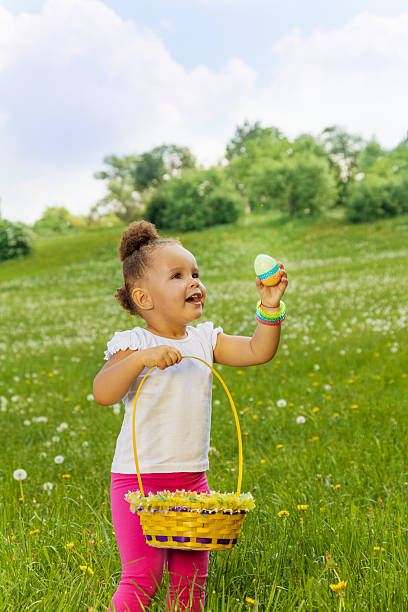 istock Positive small girl with eastern egg and basket 499699889