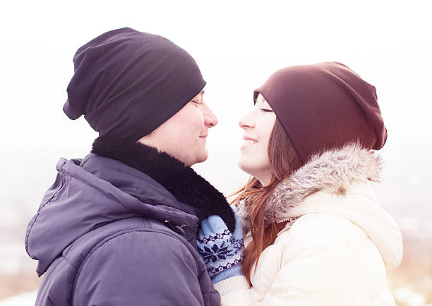istock Young smiling couple in winter park 499700297