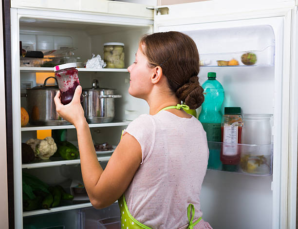 istock Happy woman near fridge 499701078