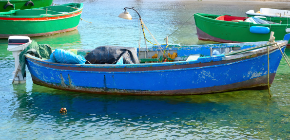 Typical fishing rowboats called gozzo in little port of Polignano a Mare, Apulia Italy