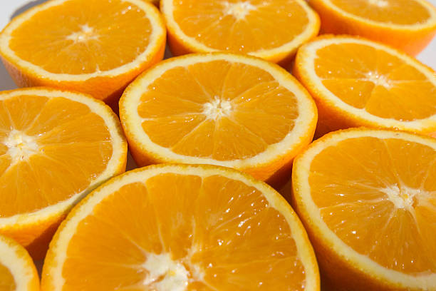 istock halved oranges , sliced orange fruits closeup 499716680