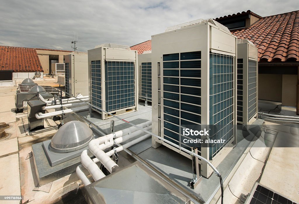 Variable Refrigerant Volume condensors for HVAC High efficiency variable refrigerant volume air conditioner units on a membrane roof. 2015 Stock Photo