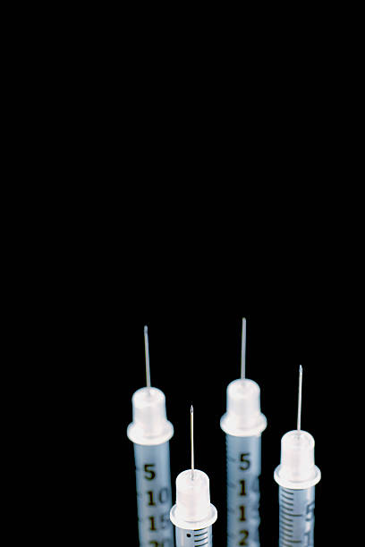 4 four syringes close up stock photo