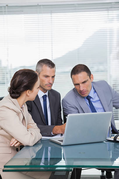 istock Serious colleagues working together on their laptop 499717653