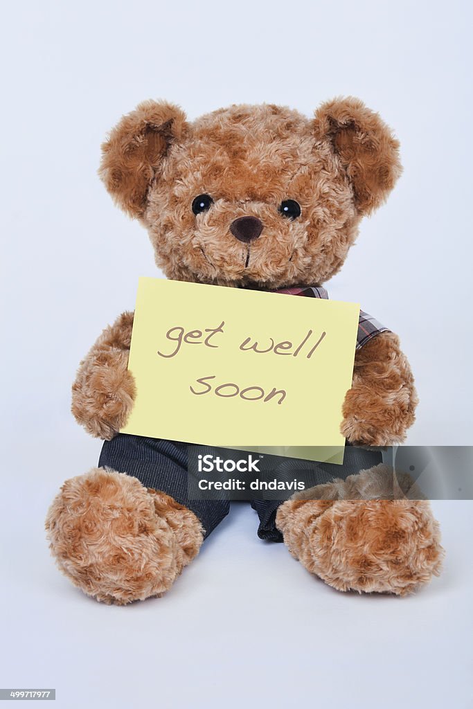 Teddy Bear Holding A Yellow Sign Saying Get Well Soon Stock Photo