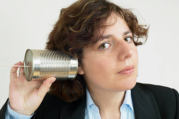 business woman speaking with tin can stock photo