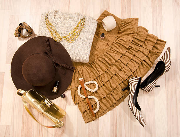 Winter sweater and leather skirt arranged on the floor.