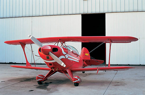 istock Red plane and open hangar door 499718077