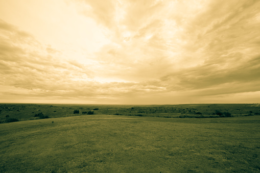 Texan wide open expansive landscape with cloudy sky old-fashioned effect split toned,