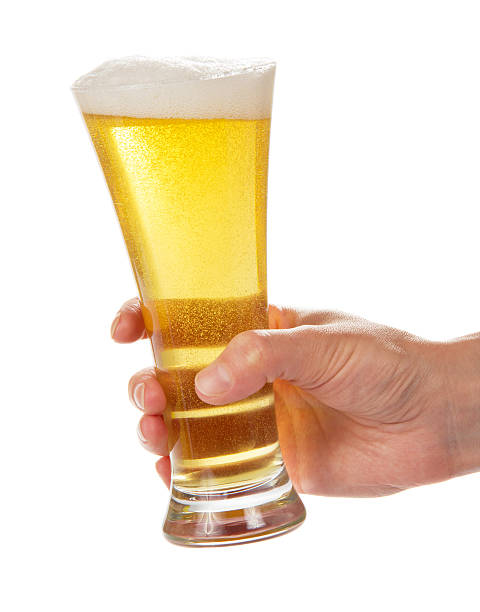 istock Glass of light beer in hand 499720175
