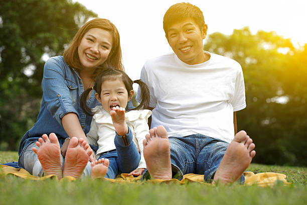 istock Happy family sitting together outdoors barefoot 499720956
