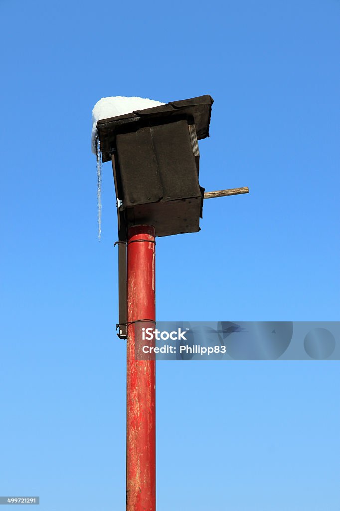 Bridhouse A colorful birdhouse in front of the deep blue sky in winter time. Animal Stock Photo
