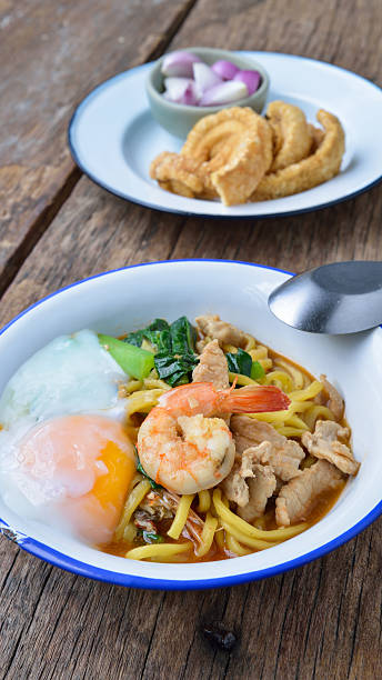 istock Stir fried yellow noodles with seafood , pork and  egg 499721964
