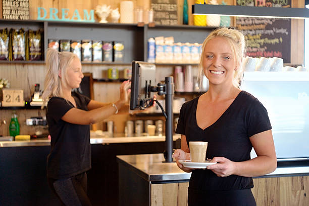 Female Barista Serving Latte