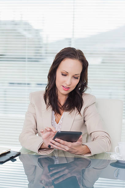 istock Concentrated businesswoman working on her tablet pc 499723345