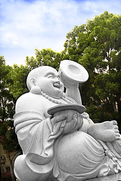 White Laughing Buddha Statue White Fat Laughing Buddha Statue at a Mahayana Buddhist Monastery laughing buddha garden statue stock pictures, royalty-free photos & images