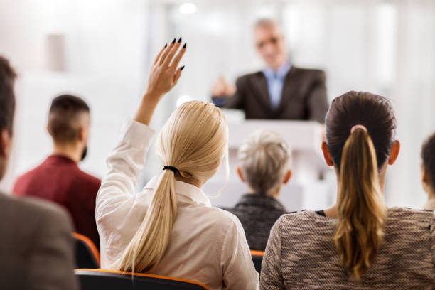 istock Back view of a businesswoman asking a question. 499731764