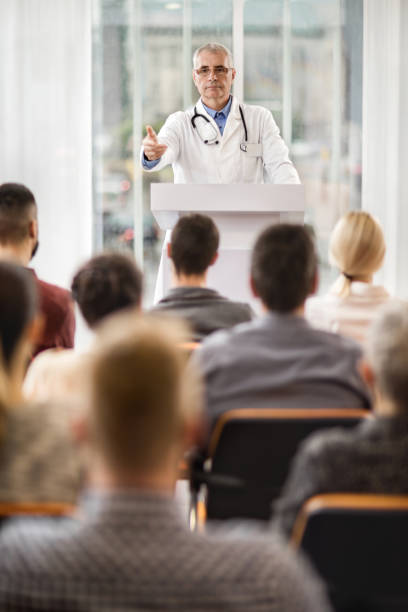 istock Senior doctor giving a speech on education event. 499732408