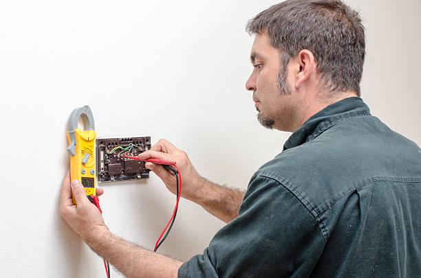 Technician working on a thermostat stock photo