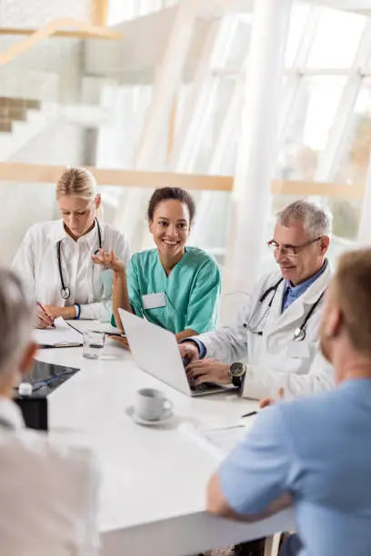 Photo of Multi-tasking healthcare workers working at doctor's office in the hospital.