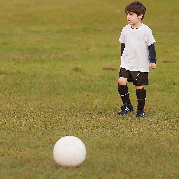 istock Kid playing football 499738783
