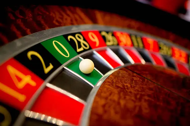Roulette at the casino with the ball on green zero