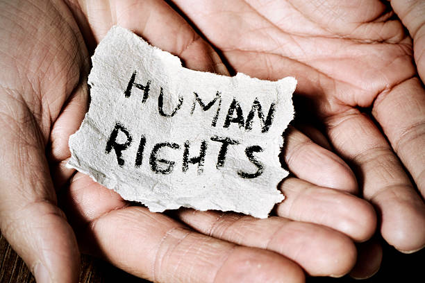 young man with the text human rights closeup of the hands of a young man with a piece of paper with the text human rights written in it, with a dramatic effect equality stock pictures, royalty-free photos & images