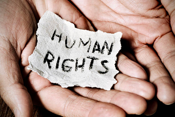 young man  with the text human rights closeup of the hands of a young man with a piece of paper with the text human rights written in it, with a dramatic effect equality stock pictures, royalty-free photos & images