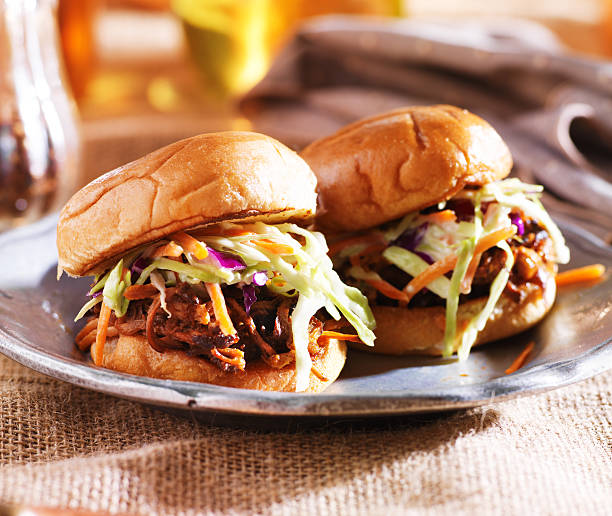 pulled pork sandwiches with bbq sauce and slaw pulled pork sandwiches with bbq sauce and slaw shot with select ive focus coleslaw stock pictures, royalty-free photos & images