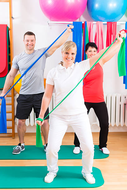 istock Physiotherapist giving patients gymnastic exercise 499739526