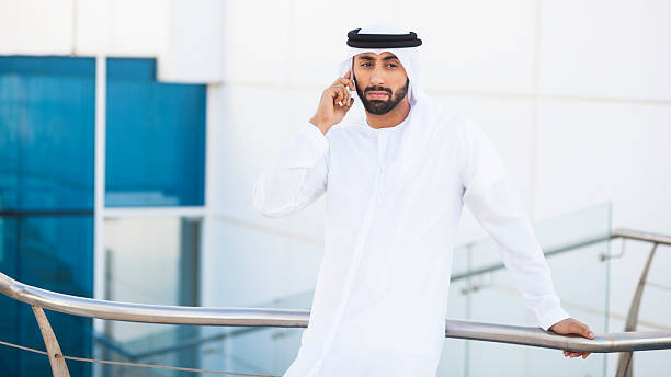 istock Concerned Arab Man Talking On Phone Outside Office 499740352