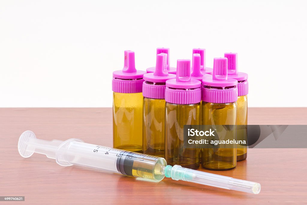 Syringe and bottles. Studio shot of a syringe and some medicine bottles Beauty Treatment Stock Photo