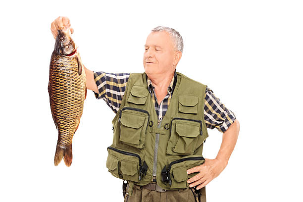 istock Proud mature fisherman holding a big fish 499740929