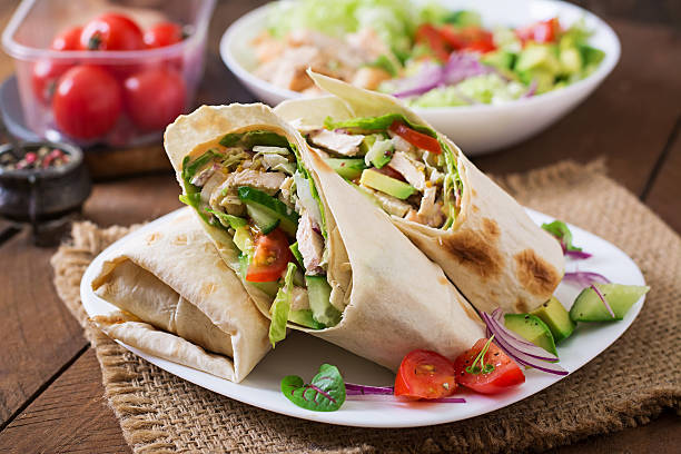 istock Fresh tortilla wraps with chicken and fresh vegetables on plate 499742030