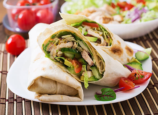 istock Fresh tortilla wraps with chicken and fresh vegetables on plate 499742090