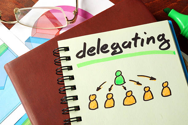 Notebook with  delegating sign on a table. Business concept.