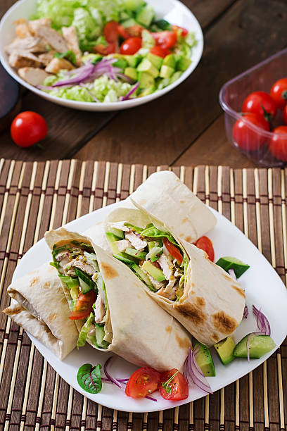 istock Fresh tortilla wraps with chicken and fresh vegetables on plate 499742182