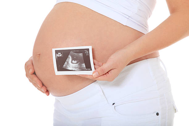 istock Pregnant woman holding sonogram 499743788