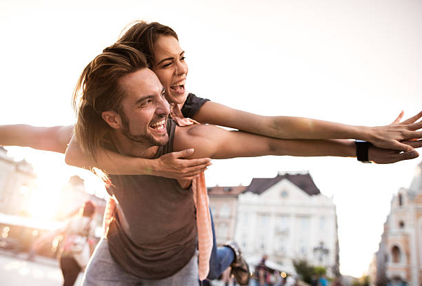istock Cheerful couple having fun while piggybacking in the city. 499744822
