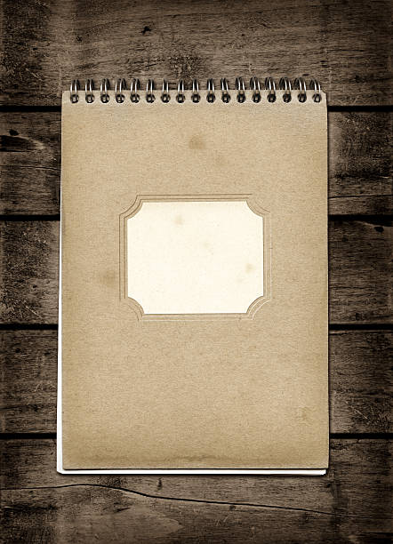 istock Closed spiral Note book on a dark wood table 499746246