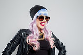 Portrait of happy blue-pink hair carefree girl wearing leather jacket