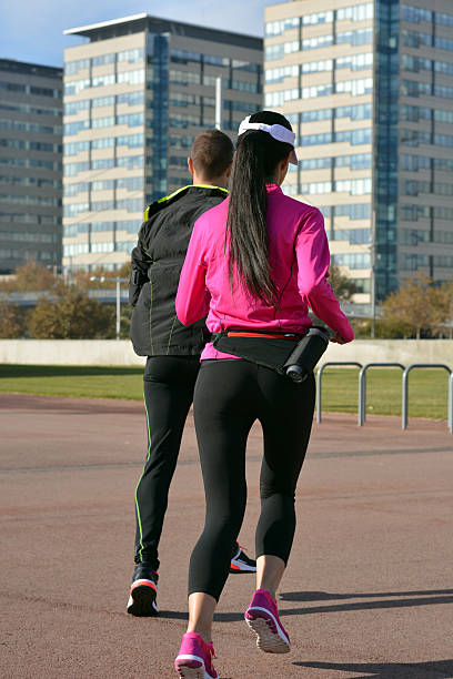 couple practicing running in the city stock photo