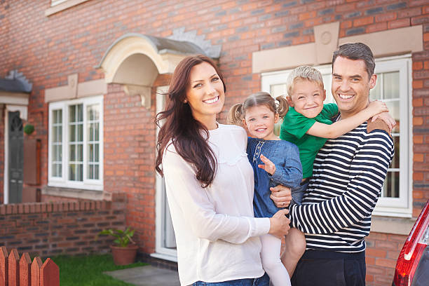 istock young family outside their home 499747046