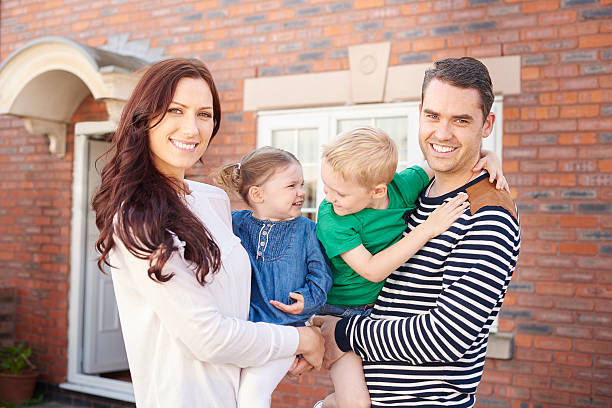 istock happy family outside their home 499747678